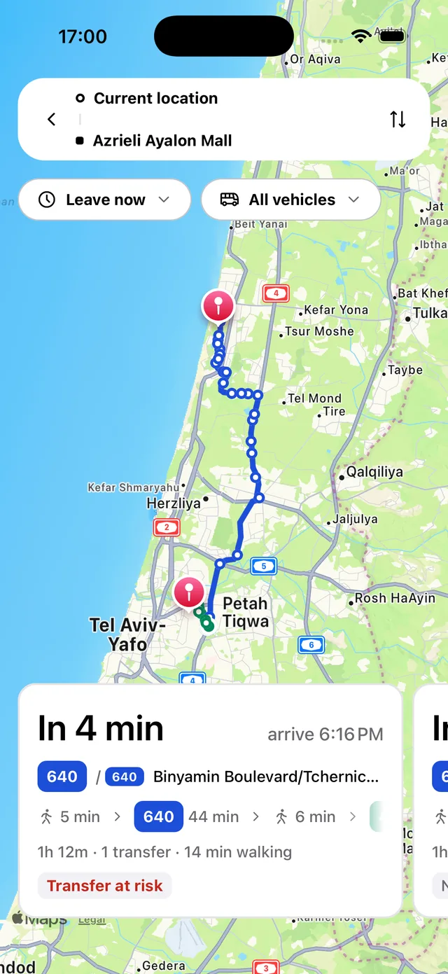 Trip planner showing a route on the map, departure and arrival times, walking legs and a transfer warning